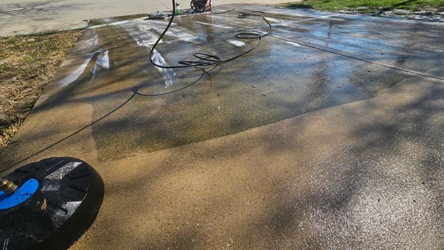 Driveway pressure washing in progress
