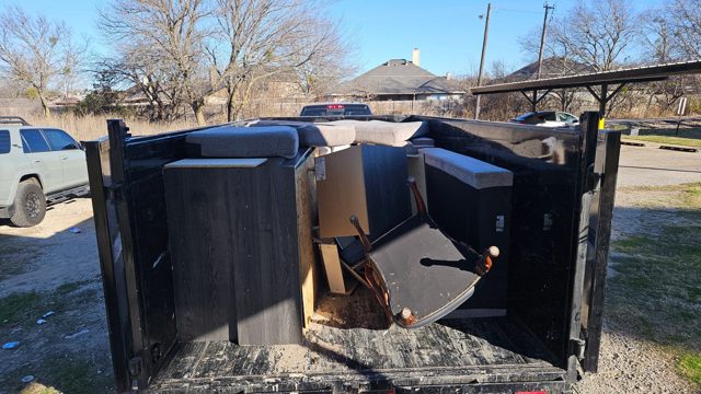 Furniture loaded in a dump trailer