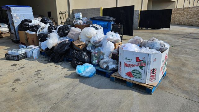 Junk staged outside a garage
