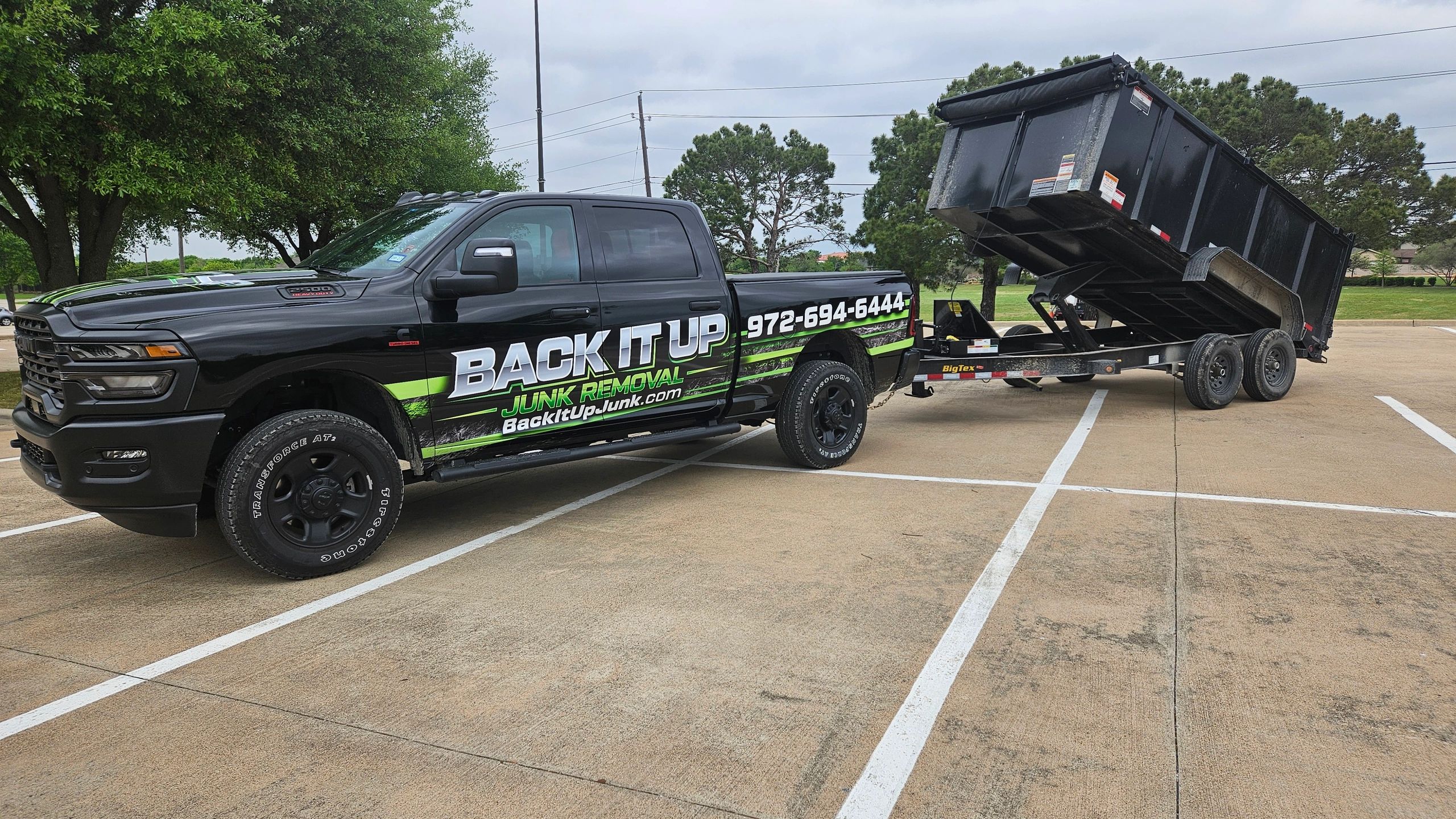 Back It Up branded Ram truck and Big Tex dump trailer